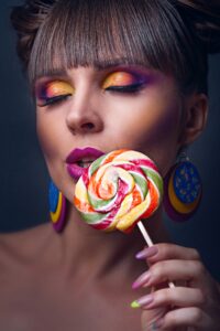 Close-UP Photo of Woman Holding Lollipop