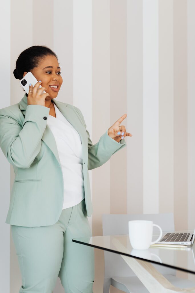 Woman in Teal Suit Talking on the Phone