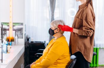 Lady with mask in chair. How 2020 Shaped the Salon and Spa Industry