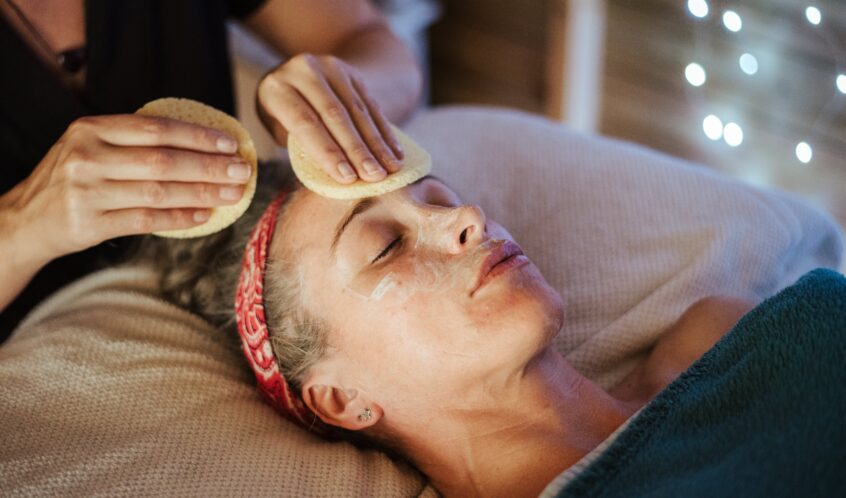 Woman removing mask from face after massage