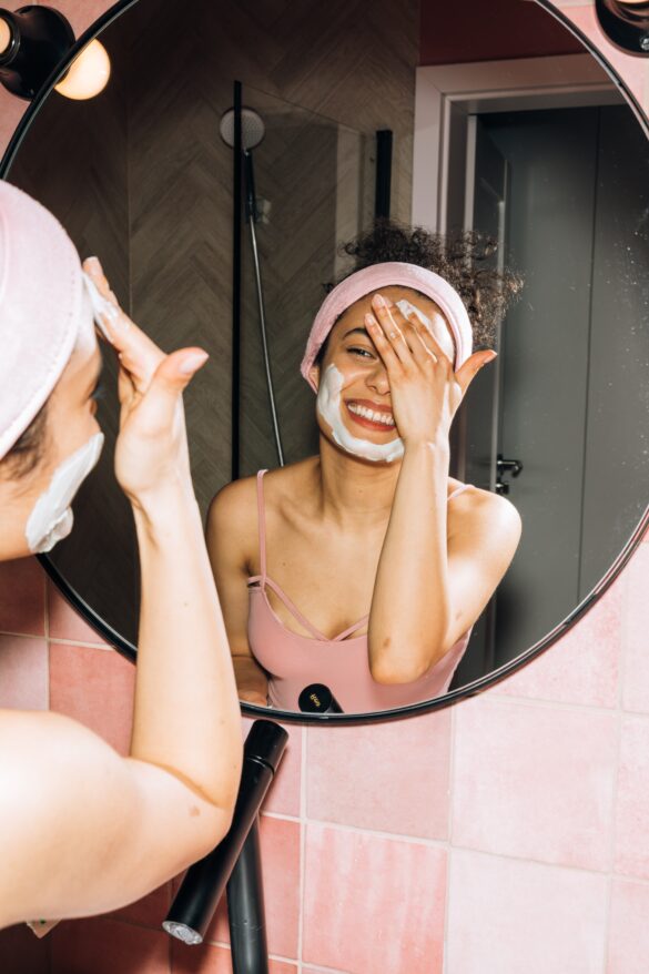 A women is applying a cream on her face